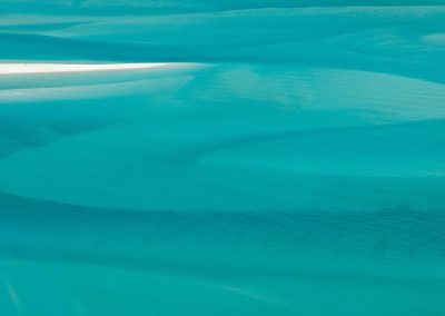 Shades of blues and turquoise in the sea near Whitsundays, viewed from an helicopter