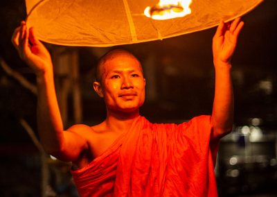Monk releasing a lantern for Yi Peng festival