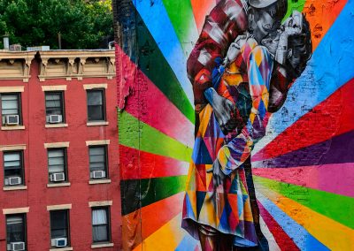 Street art of a couple kissing in rainbow colors in NYC
