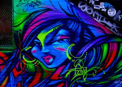 Street art portrait of a woman in vivid blue and purple colors