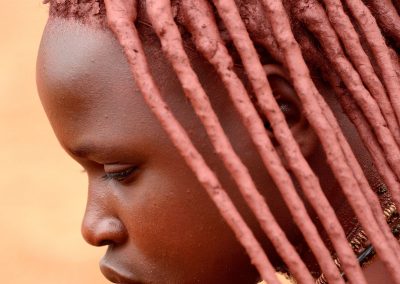 Portrait of a young himba with hair covered with red ochre