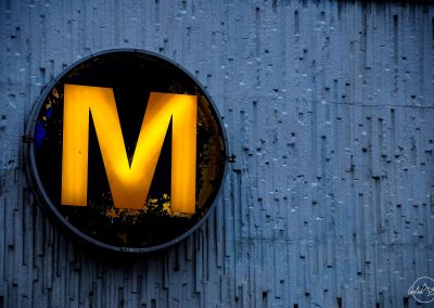 French yellow subway Metro sign on a grey wall